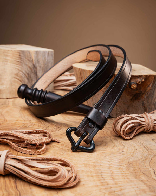 Dark brown medieval leather belt with a matte black historical buckle and edge creasing, styled for historical reenactment.