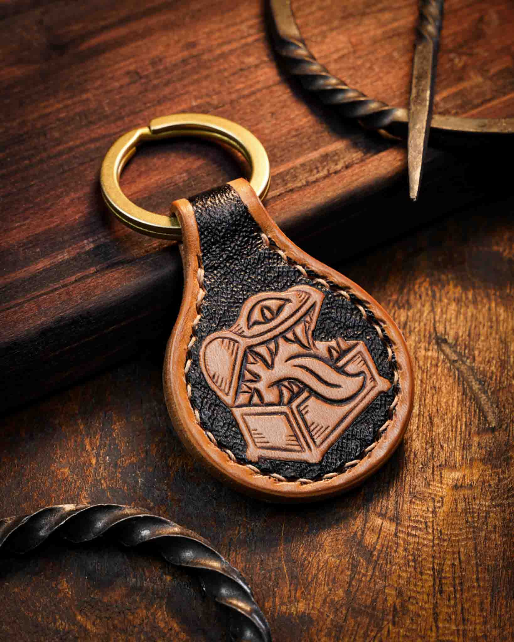 Handcrafted leather keychain featuring a hand-tooled Mimic monster design for tabletop DnD fans, set against a textured dark background, finished with stitched edges and a solid brass ring.