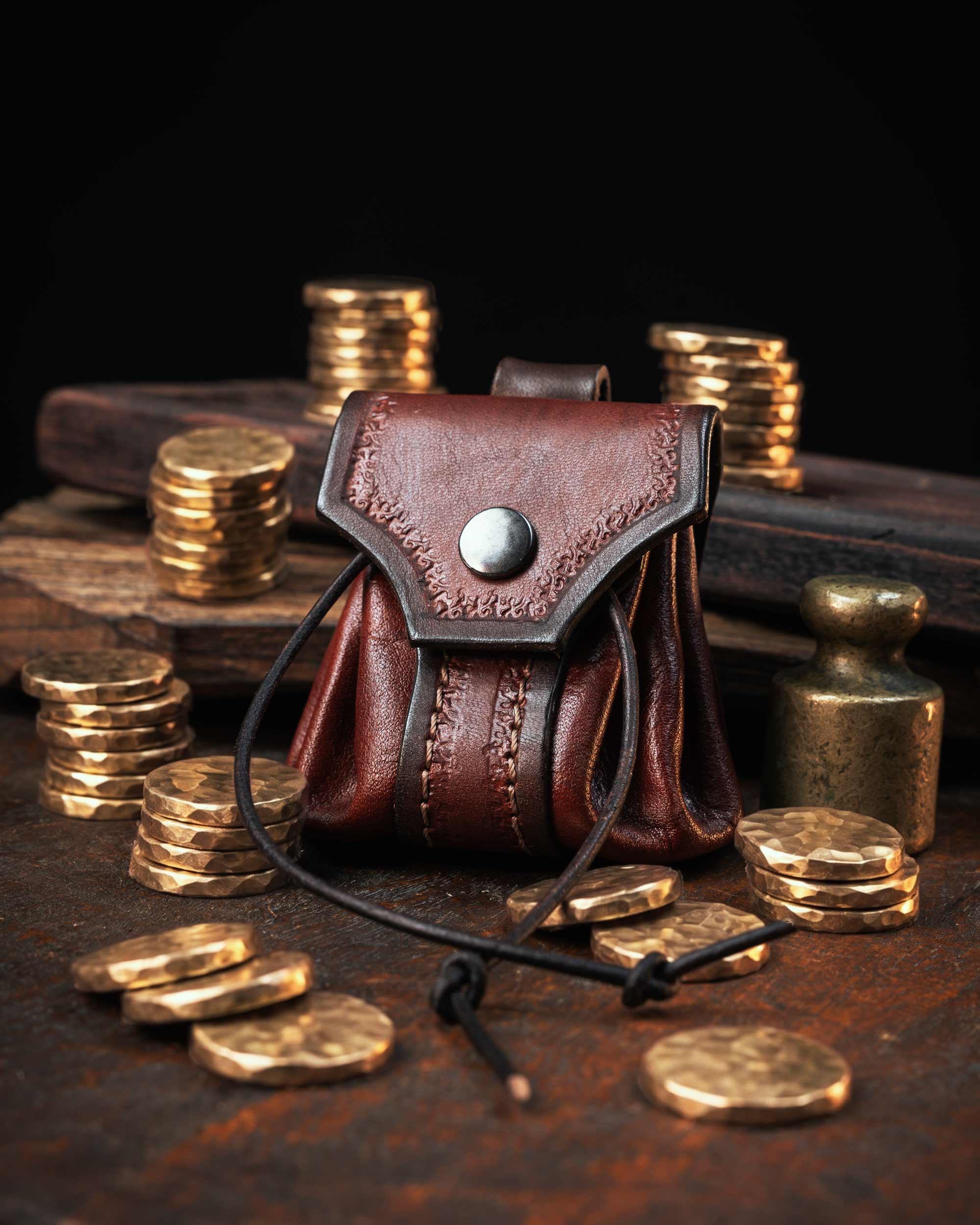 Rustic red leather belt pouch showcasing intricate saddle stitching and a versatile drawstring closure, perfect for LARP or as a custom dice bag.