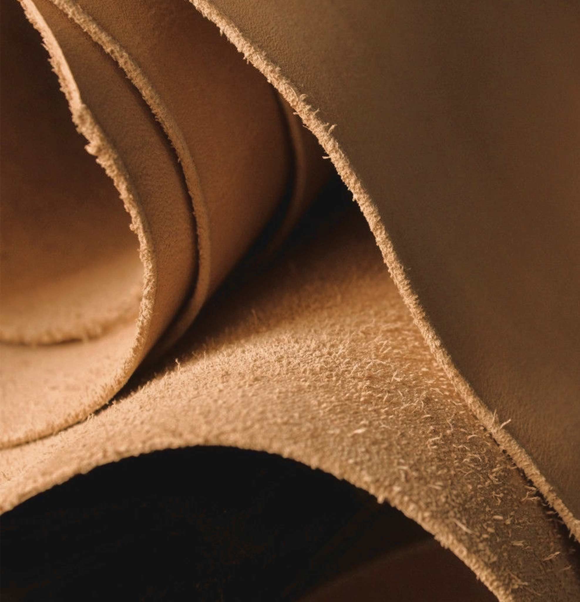 Close-up of vegetable-tanned leather used by Reliq Leather for handmade wallets, sword scabbards and artisanal leather goods, showing natural texture and durability.