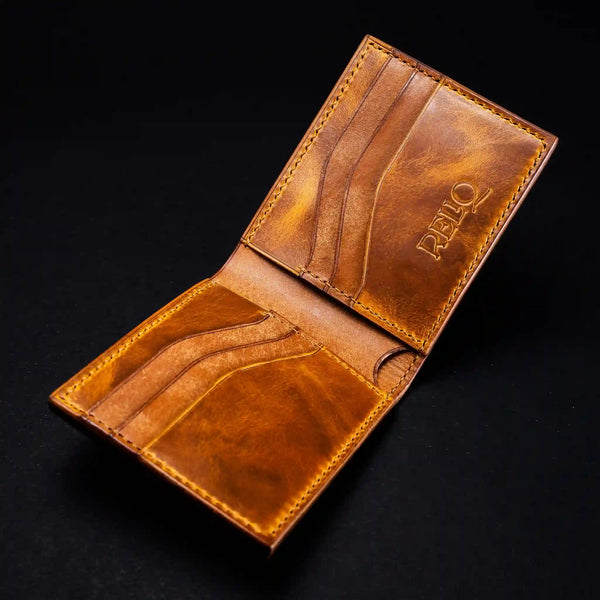 Interior of a handcrafted full-grain badalassi pueblo leather wallet revealing horizontal card slots, saddle stitching, and the Reliq Leather stamped logo.