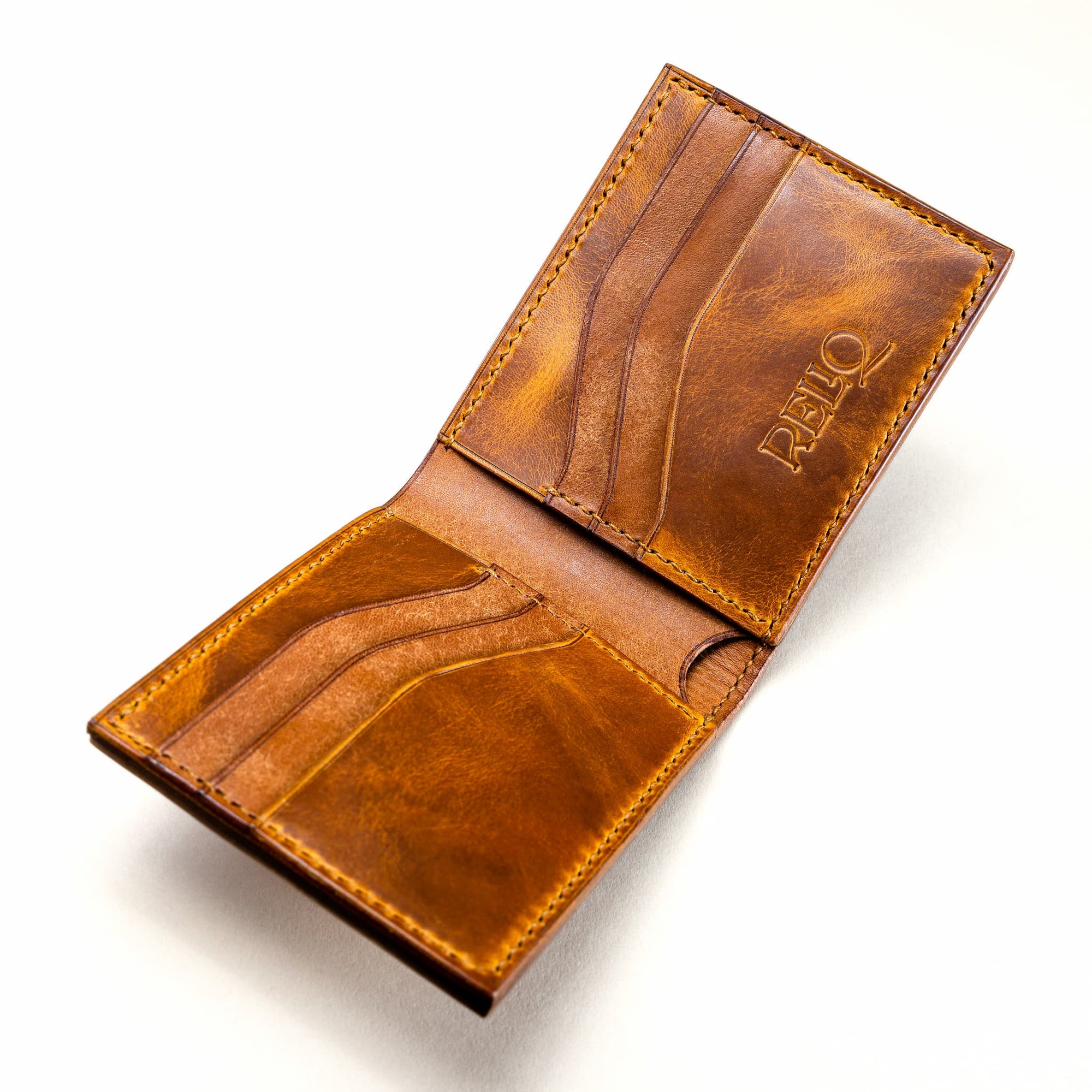 Interior stitching of the Reliq Leather Trionfo della Morte bifold wallet, handmade in vegetable-tanned leather with hand-tooled medieval design.