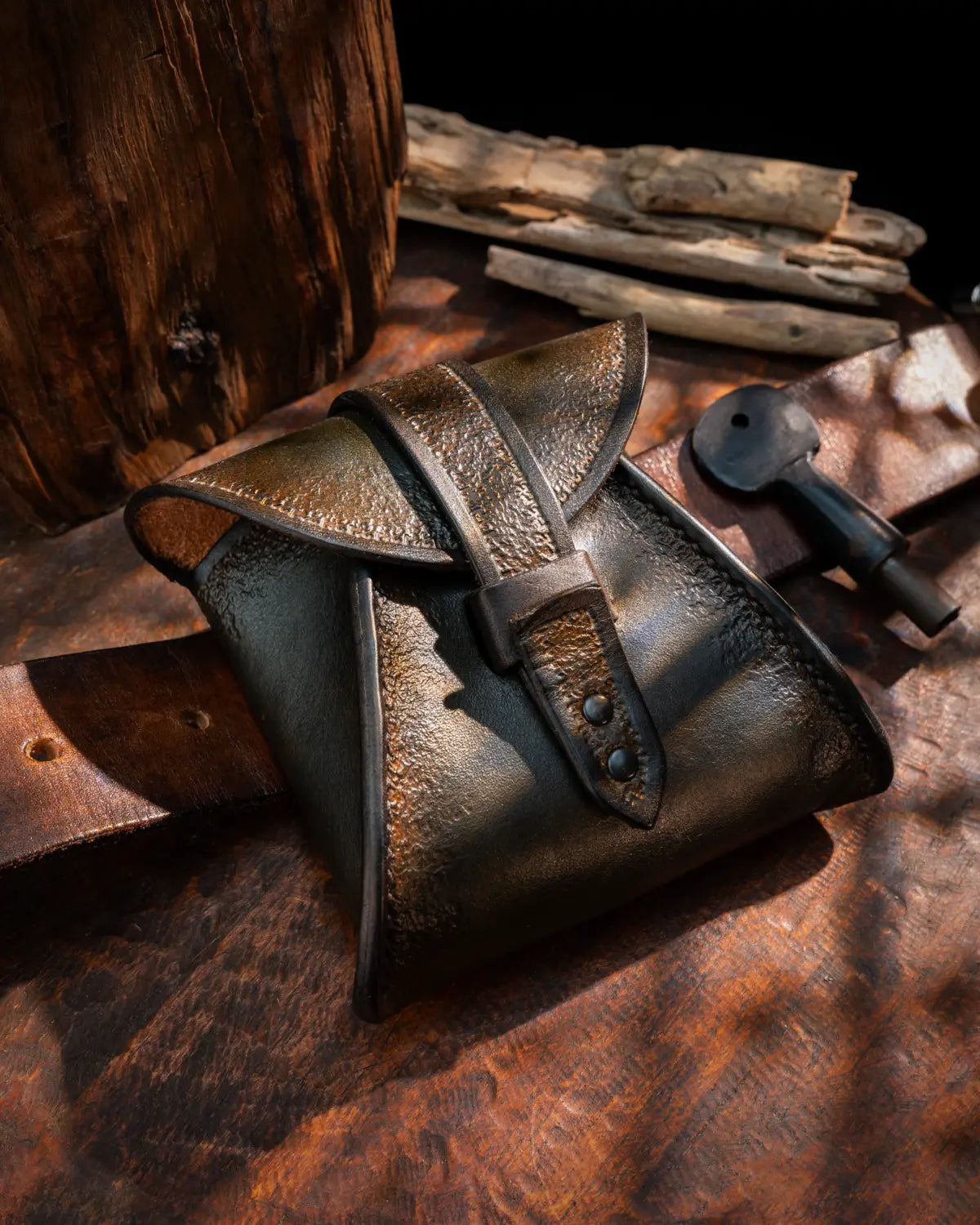 Olive green hand-tooled mens leather pouch with brown accents built for bushcraft and outdoor carry