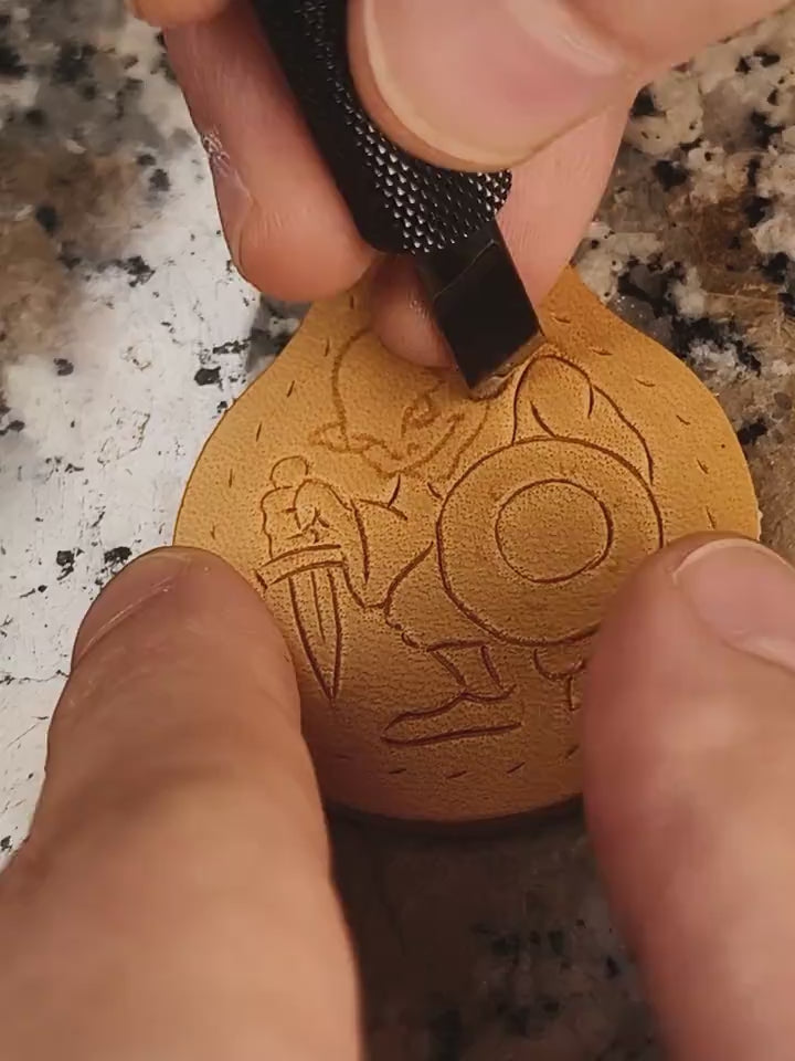 Hand-tooling a leather Goblin keychain. Short video showing the leather carving process for D&D and RPG accessories.