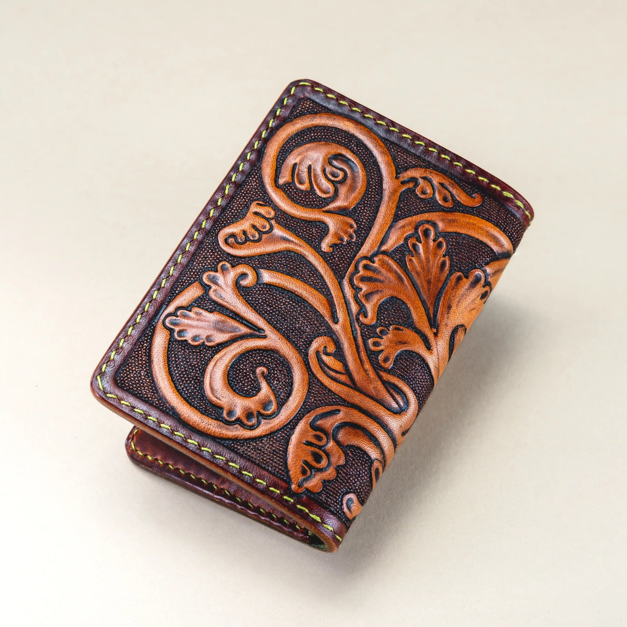 Reverse side of the Western Dragon card holder wallet, hand-tooled with medieval-inspired foliage patterns in mahogany Italian vegetable-tanned leather.