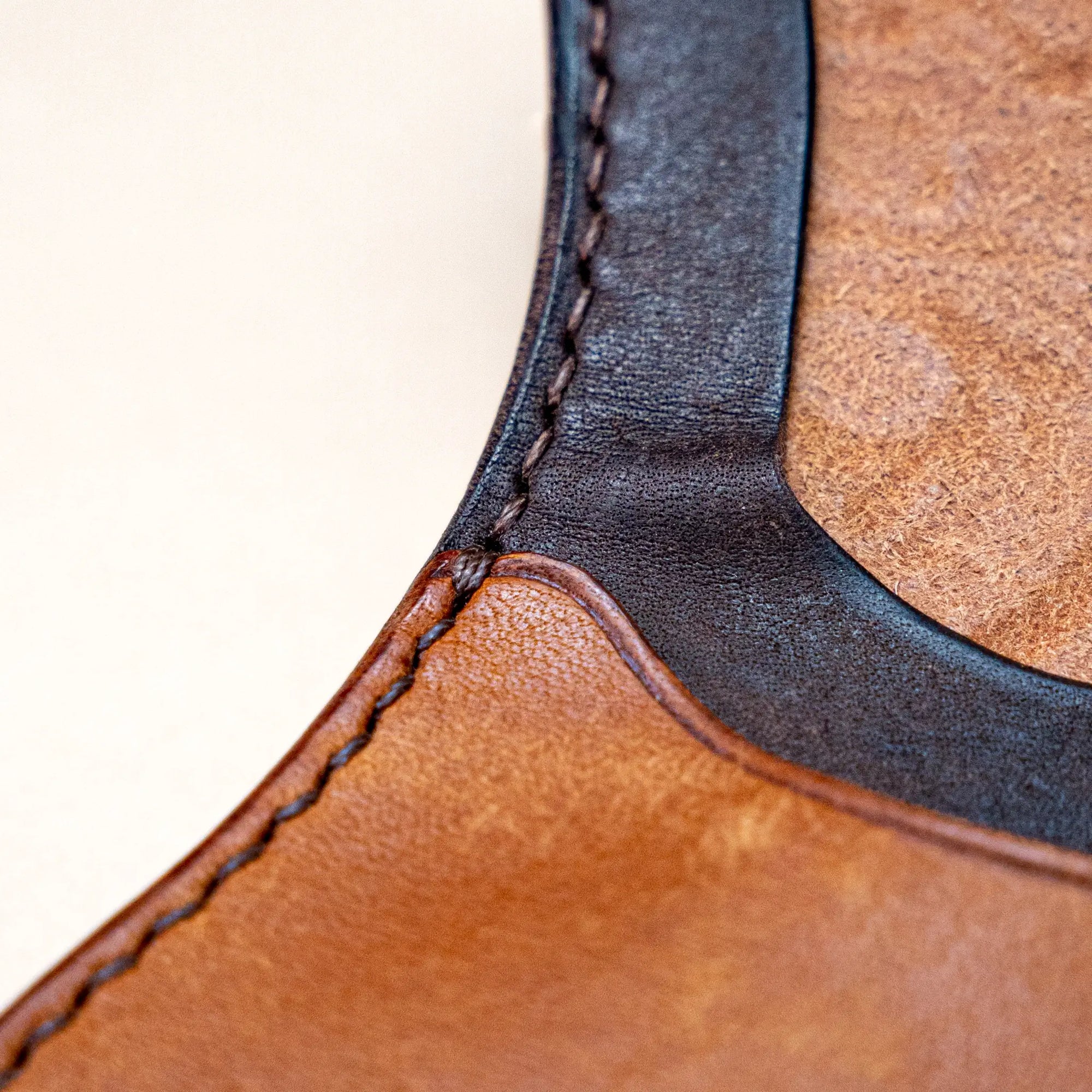 Detail of saddle stitching on Reliq Leather Gryphon coin purse, hand-sewn with waxed linen thread.