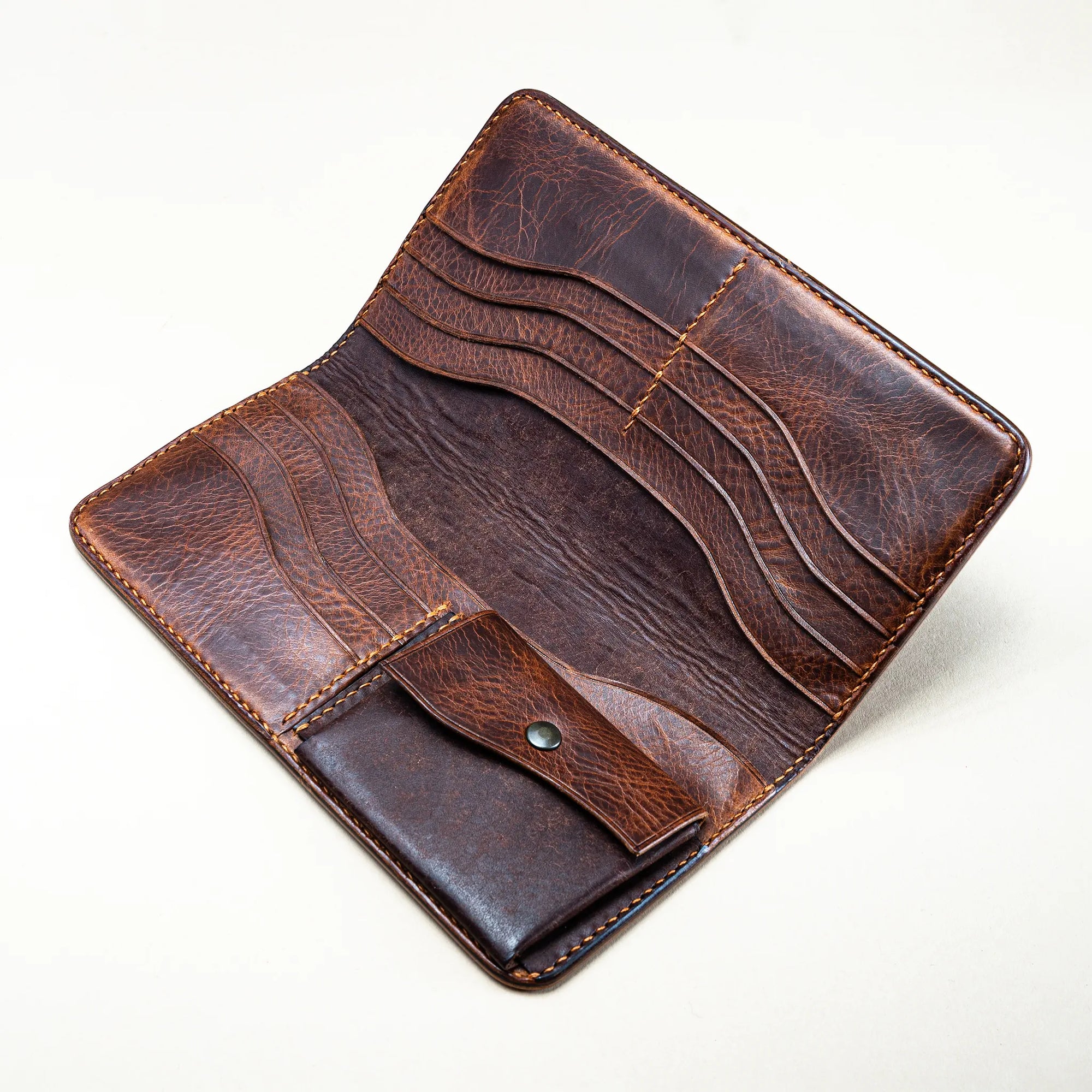 Interior of Reliq Huon de Bordeaux long wallet, with multiple card slots, coin pocket, and brown vegetable-tanned Italian leather.