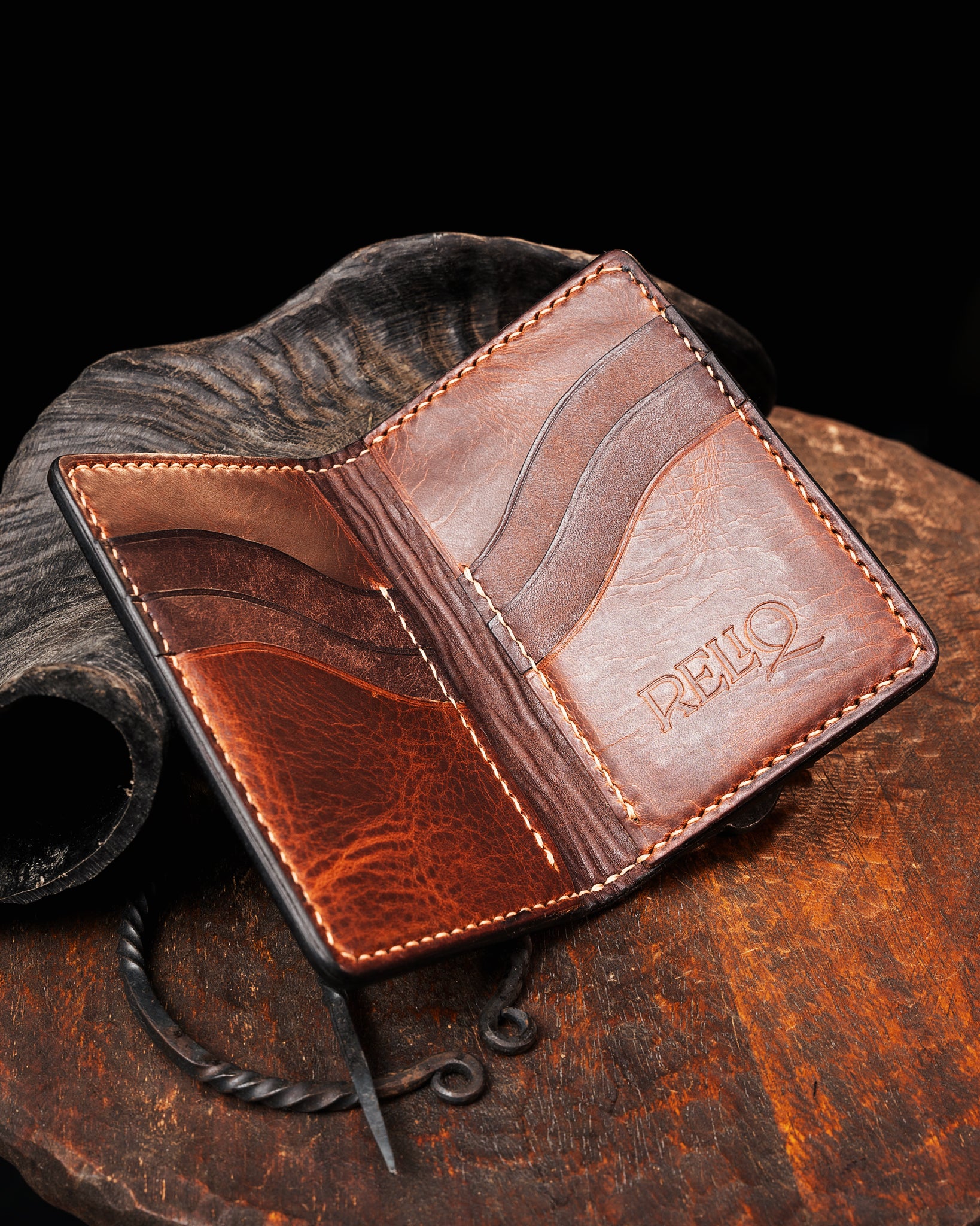 Interior view of the medieval leather card holder, featuring two-tone brown leather, multiple card slots, saddle stitching, and the embossed Reliq Leather logo.