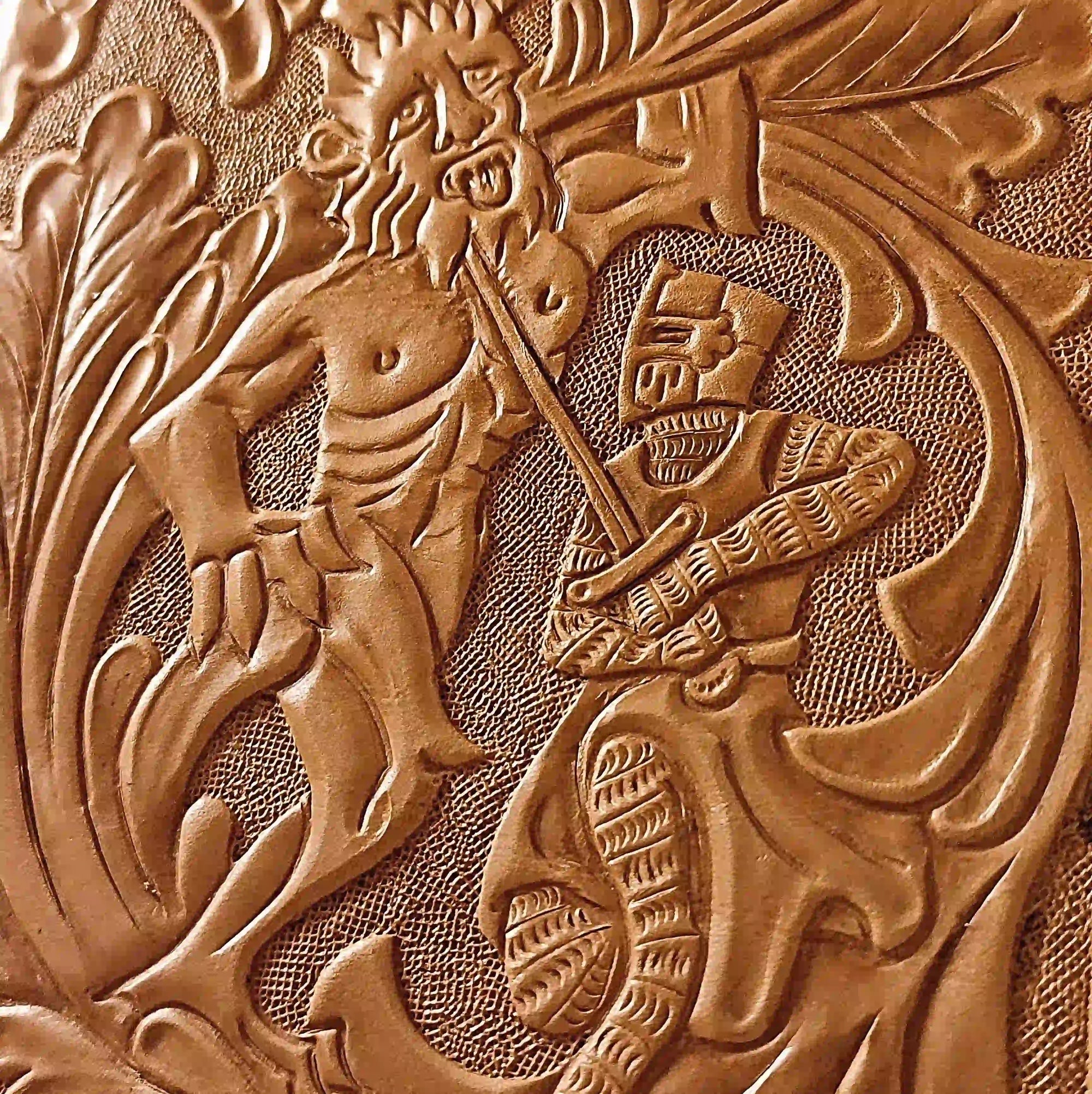 Hand tooled leather artwork by Reliq, depicting a medieval knight fighting a giant, inspired by Huon de Bordeaux illuminated manuscripts