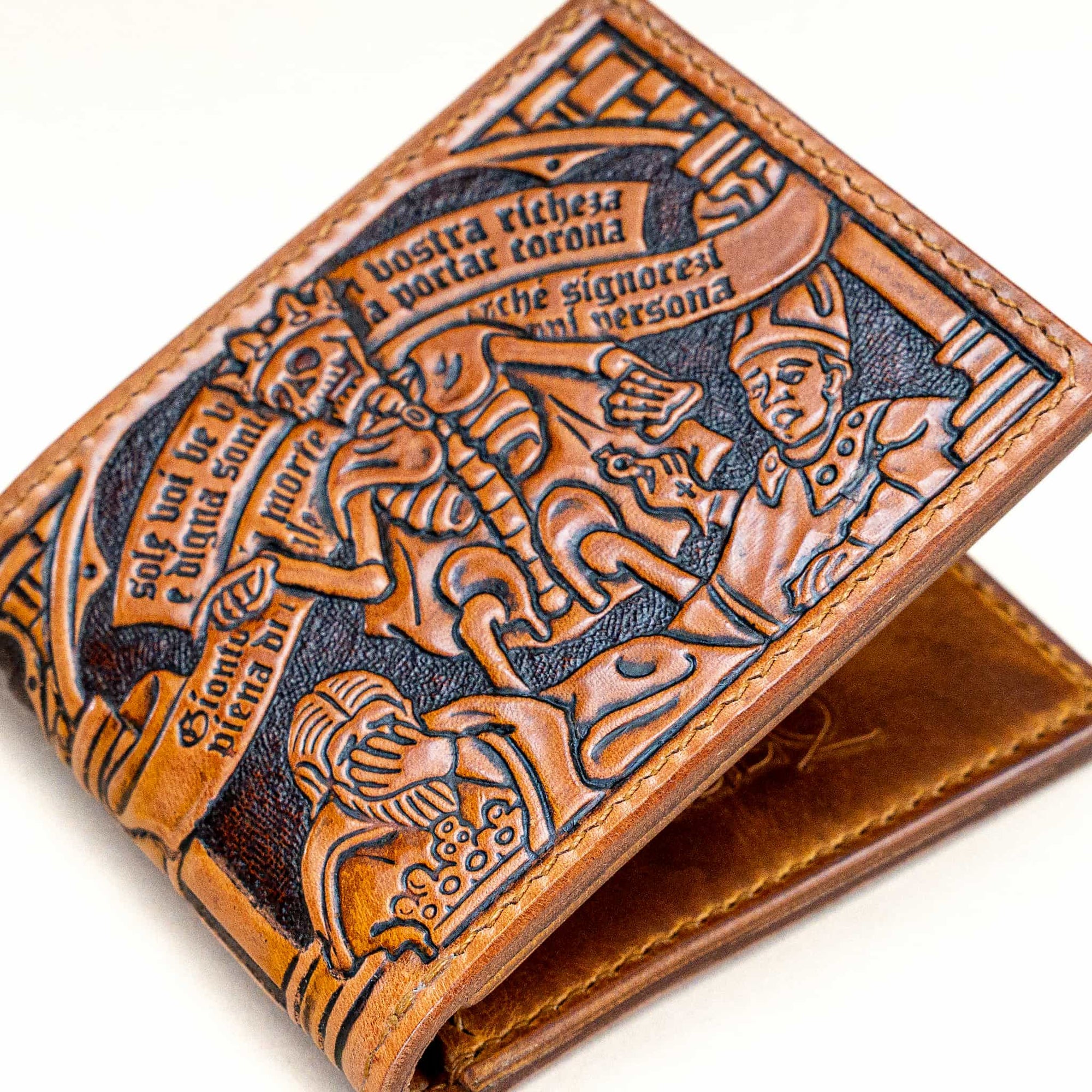 Close-up of the hand-tooled Trionfo della Morte wallet by Reliq Leather, inspired by the 1485 fresco in Clusone. Detailed medieval design on vegetable-tanned leather.